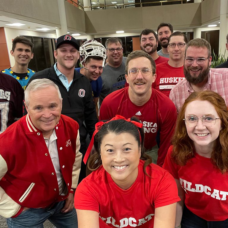 FHU Omaha office group photo sporting their Wildcats gear for homecoming week