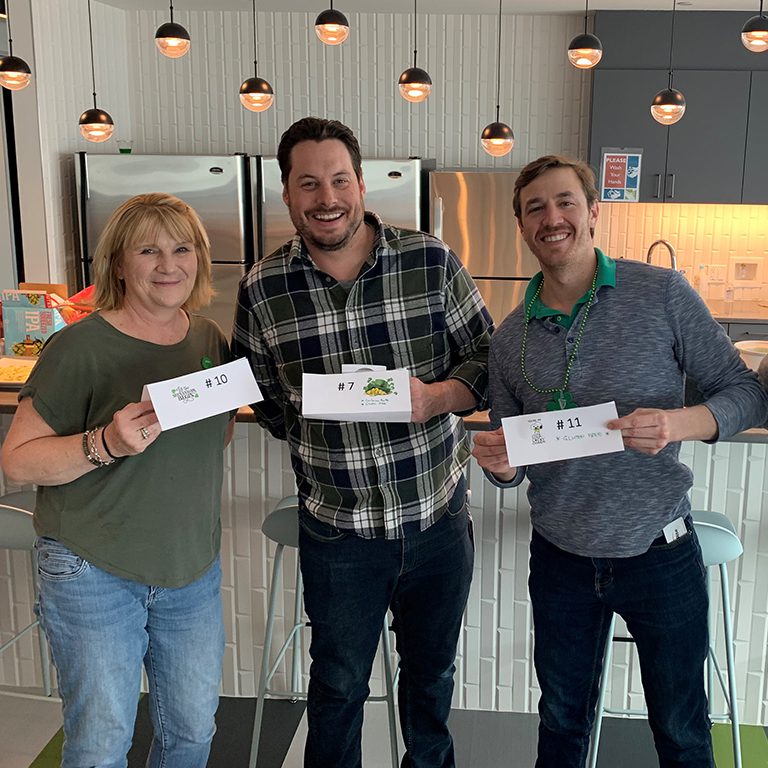 Three winners of the FHU Green cookoff posing with their winning food signs