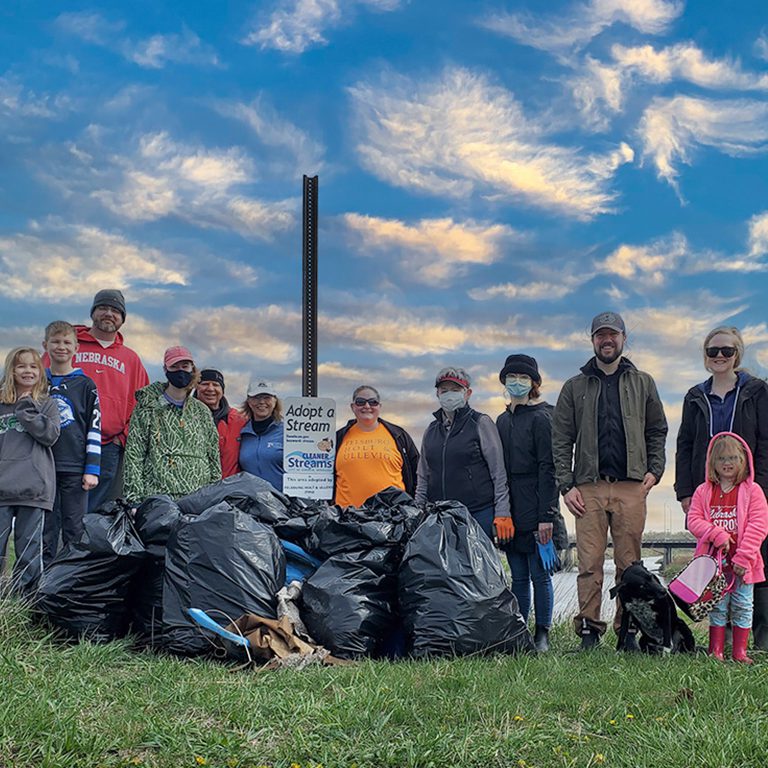 Group photo of FHU staff and family members after picking up trash at Creek Week cleanup.