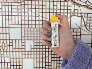 A hand holding a PEZ dispenser right-side up. The label on the dispenser reads "Ready to Dispense Your ZEV Future" with the FHU logo