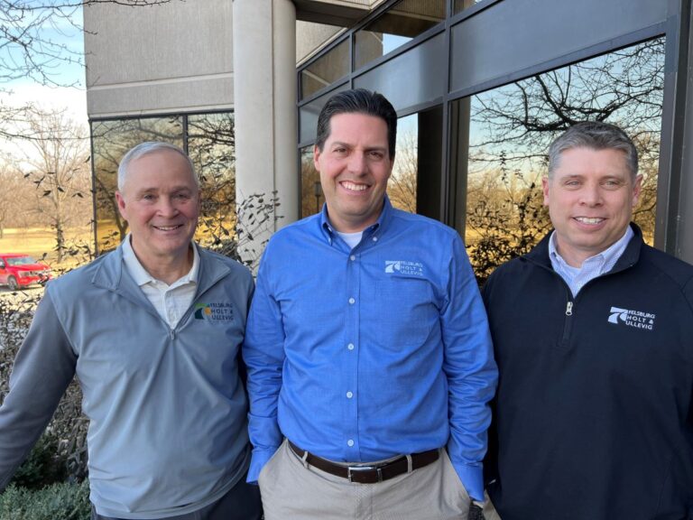 Kyle Anderson, Mark Meisinger, and Dave Lampe stand together for a photo outside the FHU offices.
